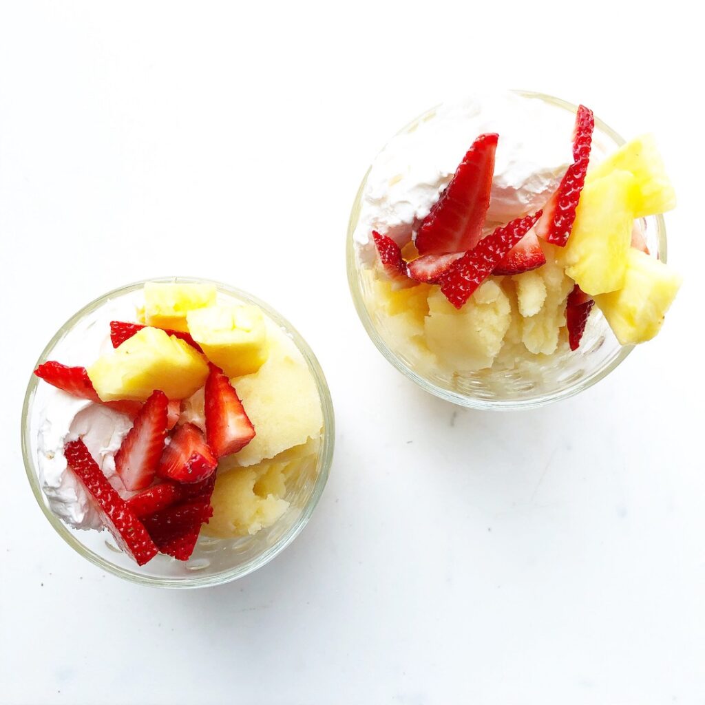 pineapple italian ice with fresh strawberries and whipped cream