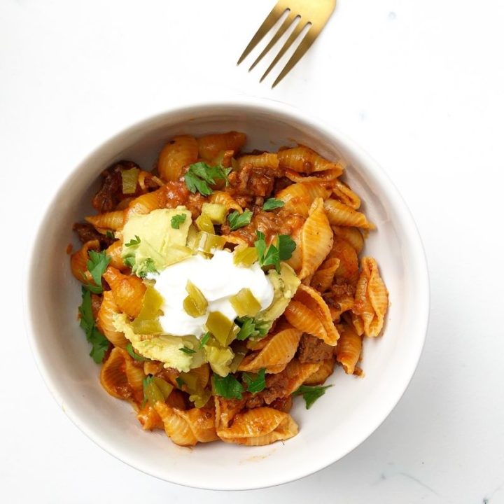 Taco Pasta in a bowl with a gold fork
