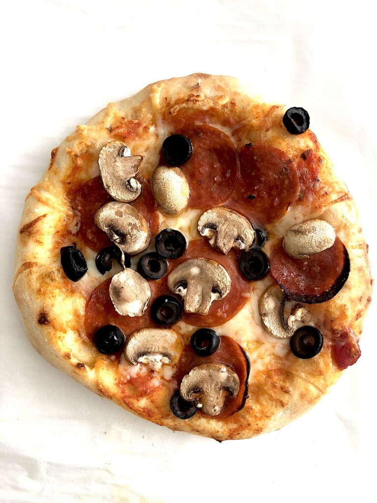 sourdough pizza with pepperoni, mushrooms, and black olives Sourdough starter pizza dough