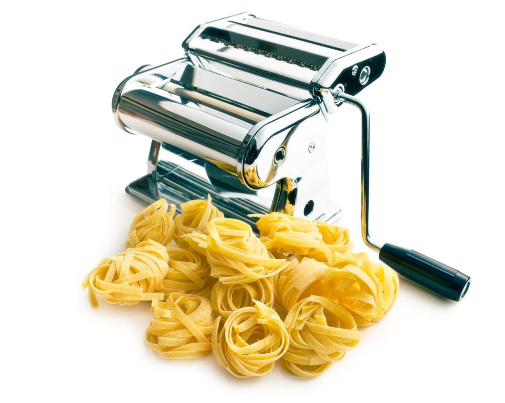 hand cranked pasta machine with fresh pasta